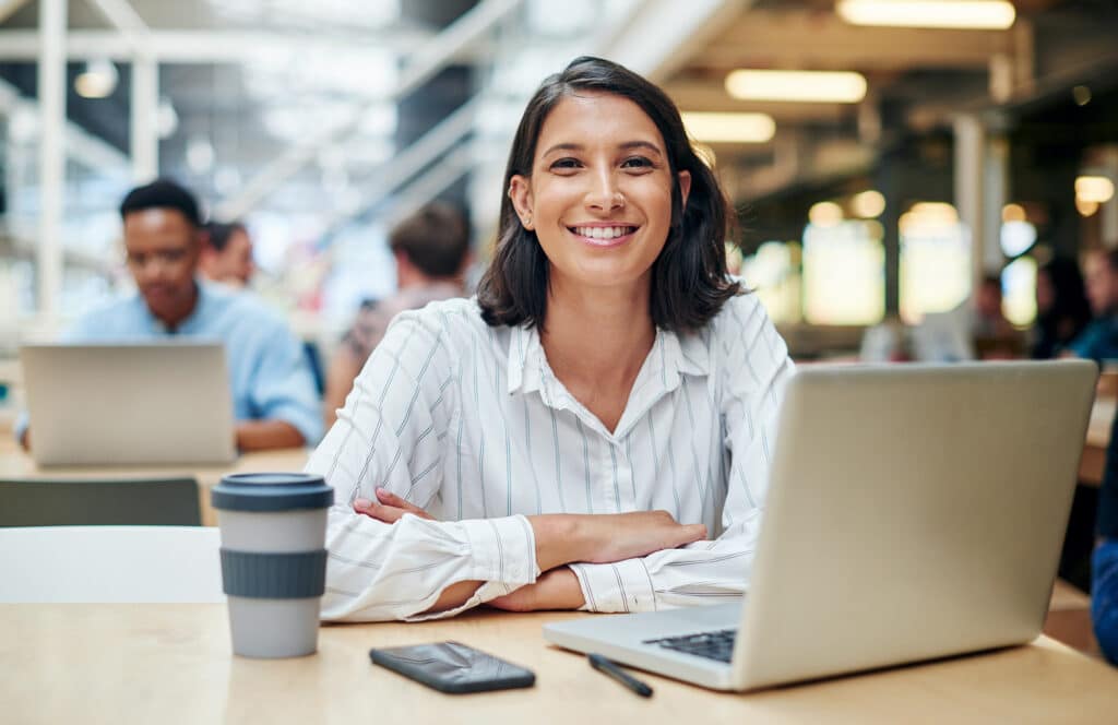 IT professional with a laptop smiling