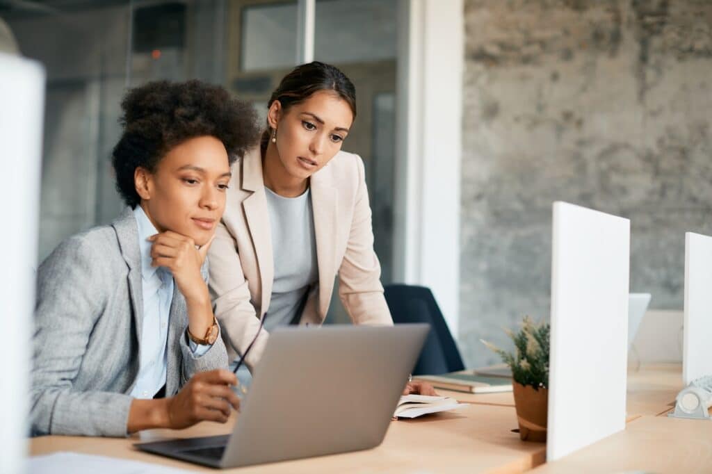 coworkers in office on computer using it outsourcing services to get remote support