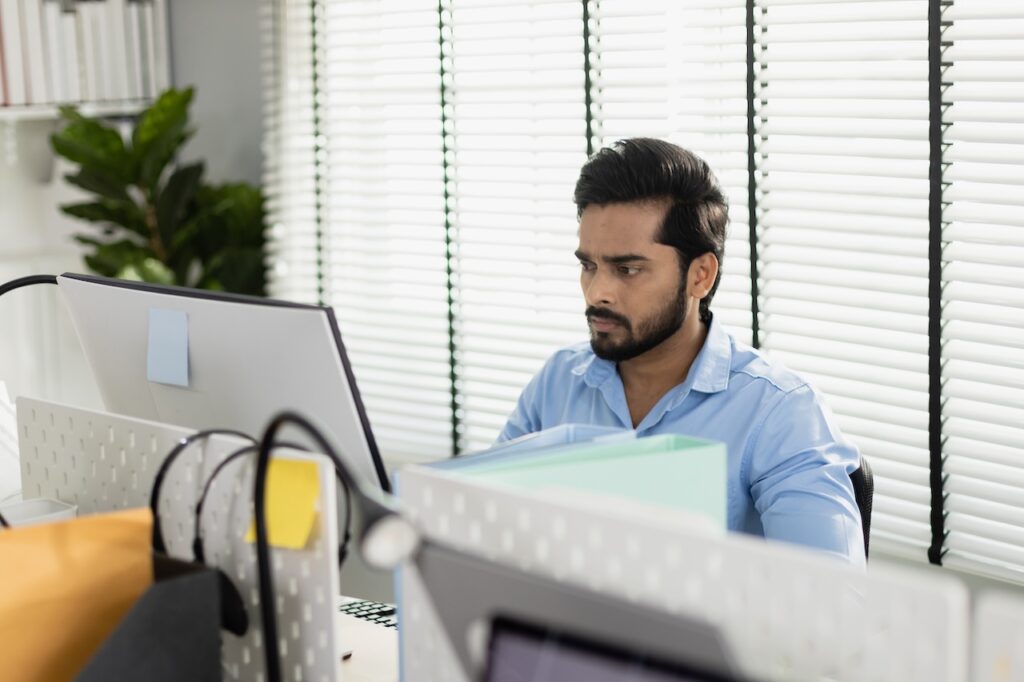 man at work in office using microsoft 365 managed services